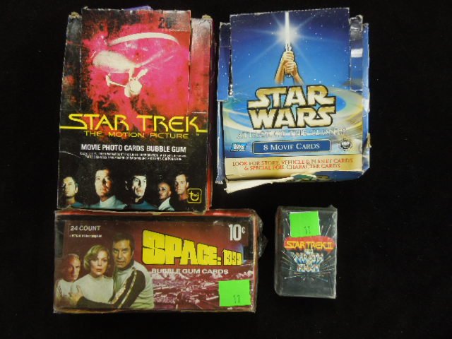 1 Lot Sci-Fi Trading Cards: Including: Star Trek Motion Picture, Star Wars Attack of the Clones, Space 1999, plus (1) pack of Star Trek II Playing Cards. Condition: Clones box as is with sealed packs, Star Trek Box worn, packs s