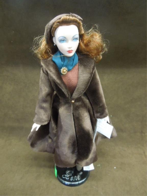 Gene "Warmest Wishes" Porcelain Doll: Gene "Warmest Wishes" porcelain doll, 15 1/2", The Gene Marshall Collection, with coat & muff, Fao Schwarz nut cracker accessory, designed by Mel Odom (signed in card), 1995 Ashton-Drake Galleries wit