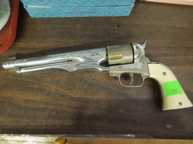 Hubley Colt .45-6 Shot Cap Revolver: Hubley Colt 45, six shot cap revolver, removable bullets, chromed with faux ivory handles, overall length 13 3/4", mid 20th C. CONDITION: Areas of wear, played with working condition.