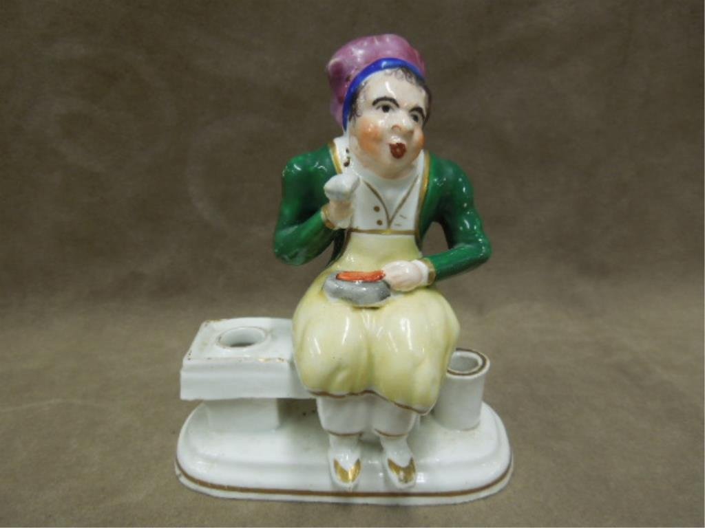 Staffordshire Figural Porcelain Inkwell: Staffordshire figural porcelain inkwell with pen holder, man eating on bench, hand painted with gold accents, 2 1/4" x 3 3/4" x 4 1/4" height, mid 19th C. CONDITION: Minor paint loss on figure & bench