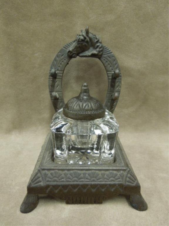 Victorian Glass Inkwell, Cast Iron Base: Victorian glass inkwell on cast iron base, ribbed glass well with iron lid, horse head crested horse shoe double pen holder back, late 19th C., 3 7/8" x 3 7/8" x 5 1/4" height, late 19th C. CONDITION: