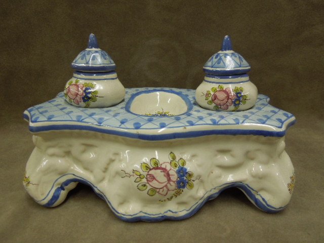 French Faience Pottery Double Inkwell: French Faiece pottery double inkwell, hand painted floral design, covered pottery, removable wells, 19th / 20th C., 8 1/2" x 5" x 5". CONDITION: Paint chip loss on tips of both finials, minor wear oth