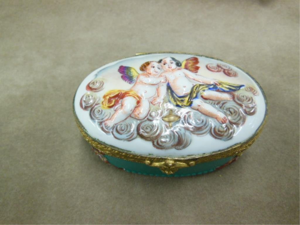 Capodimonte Porcelain Pill Box: Capodimonte porcelain pill box, B. Altman & Co. New York, raised work cherubs on lid, floral design on base & interior, mark on inside back, 3" x 2 1/8" x 1 3/8". CONDITION: very minor wear from age