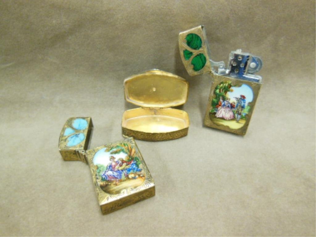 3 Enamel Items: Three enamel items, includes: two lighter cases both gold wash over 800 silver figural courting scenes with floral chasing; plus gold wash over base metal pill box, with courting scene on lid & floral