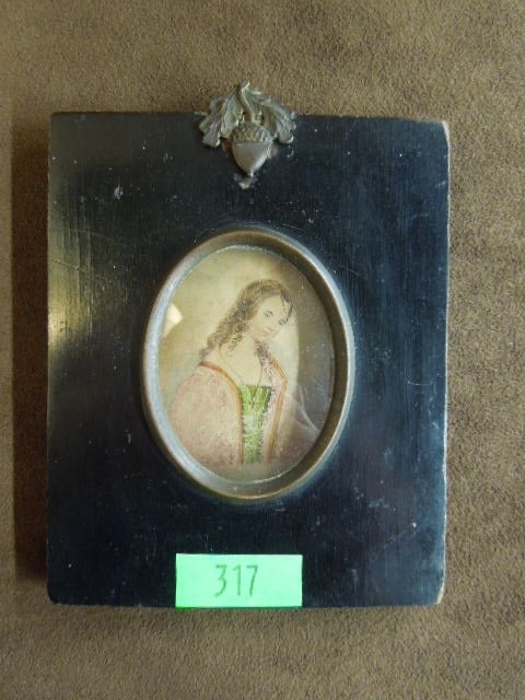Watercolor Portrait of Young Lady: Early 19th C. watercolor portrait of young lady in ebonized wood frame, 2 1/2" oval convex glass, brass acorn accent crest, 4" x 5" wood frame. CONDITION: Water color loose from frame, held on one sid