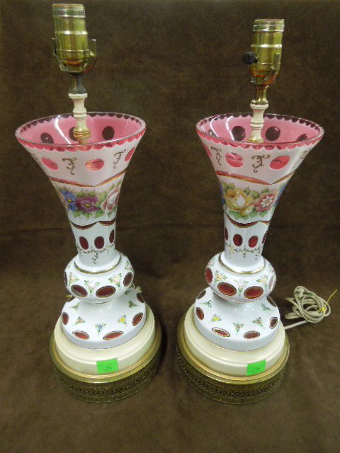 Pr Cased Glass Urn Form Table Lamps: Pair of cased glass urn from table lamps, white cut to cranberry glass with floral painted decoration and high lights, brass bases. CONDITION: One lamp has minor chip on side of base, minor chips on r
