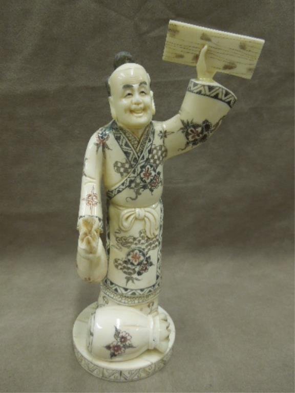 Chinese Bone Carved Workman: Chinese carved bone workman, polychromed, he holds a wood panel & bag, another bag is at his feet, signed on base, mid 20th c. hgt 9 1/4". [48] CONDITION: Areas of glue at hand juncture, normal wear f
