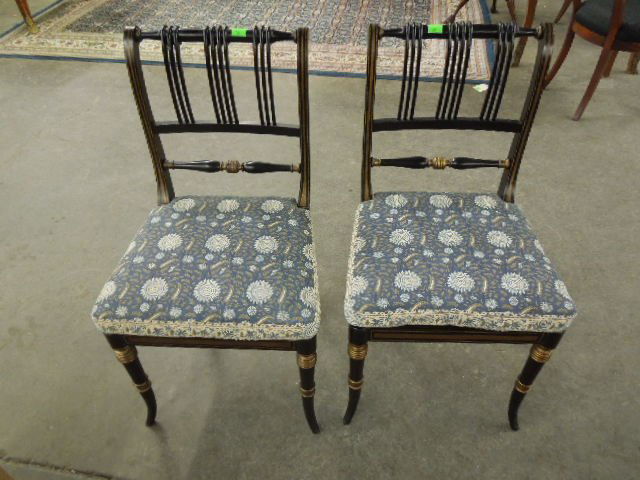 Pair Fancy Chairs: Pair of fancy chairs, ebonized & gilt hardwood; rolled backs, caned seats with cushions, 20th C., height 36". CONDITION: Modest wear.
