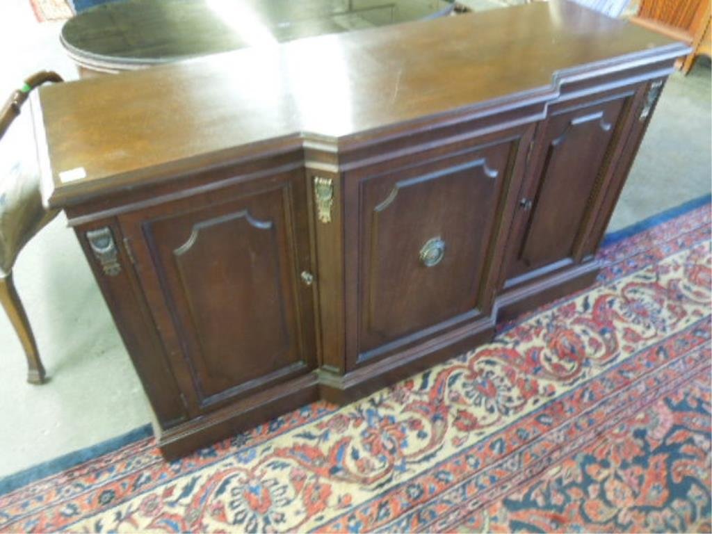 Federal Style Credenza: Federal style credenza, mahogany, 3 raised paneled doors the center with 3 interior drawers; applied brass column crest, mid 20th c. 18" x 53" x 31". CONDITION: Surface scratches.
