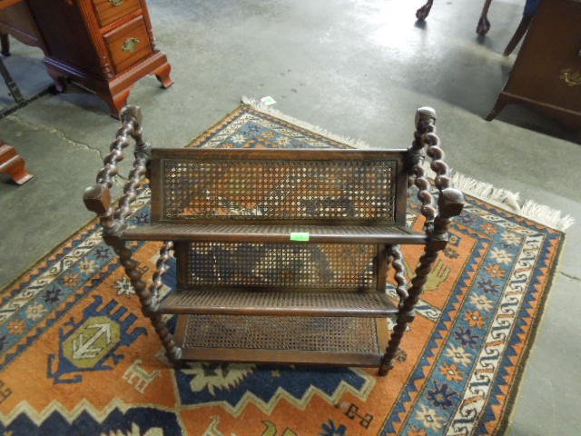 Jacobean Style Book Stand: Jacobean style book stand, oak barley twist construction with caned shelves, early 20th c. 24" x 10" x 28". CONDITION: One side of top shelf has caning loss.