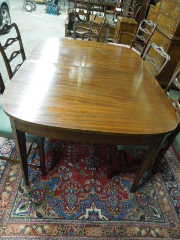 Federal Style Dining Room Table: Federal style dining room table, mahogany with ebonized line stenciling, tapered square legs, two leaves, mid 20th C., 44" x 64" x 30 1/2" CONDITION: Areas of veneer loss, two gauges on top.
