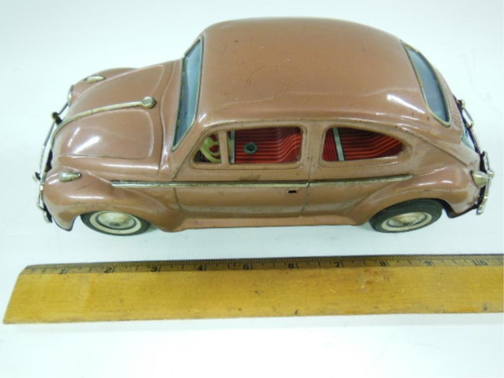 Japanese Tin Volkswagen Beetle Bump N Go Car: Japanese tin Volkswagen Beetle bump n go car. CONDITION: Broken rear engine compartment, dents, minor rust, puncture in front fender. Not tested.