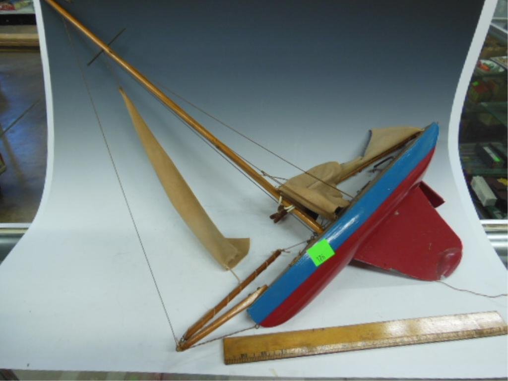 Wooden Sailboat Toy: Wooden toy sailboat, 18"l x 30" tall. CONDITION: Fair, torn sail.