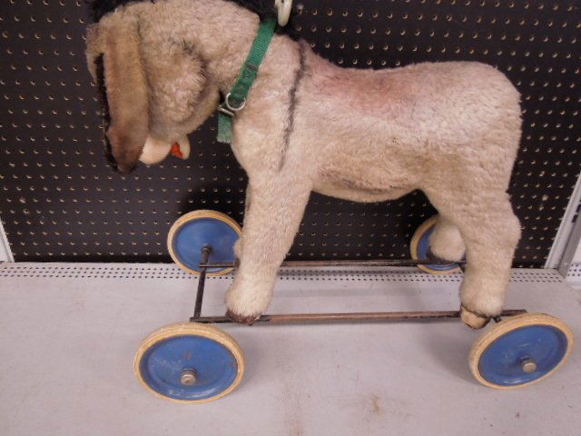Vintage Donkey Form Riding Push Toy: Vintage donkey form child's riding push toy, appears to be home made Condition; fur on donkey matted and faded, some minor rust on metal parts
