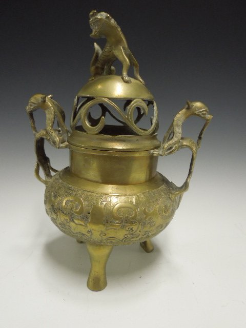 Chinese Brass Incense Burner: Chinese brass incense burner, open work scroll lid created by a seated foo dog, engraved bun form body with Dragon handles & 4 feet, chip mark on base, also marked "China", early 20th c. 12"h. CONDITI