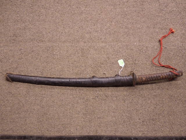 Japanese Samurai Sword: Japanese Samurai sword, probably WW II vintage, anchor mark on blade under handle, old leather scabbard sheath covers the original covered scabbard, 38 1/2" overall length 26 3/8" blade length CONDITI
