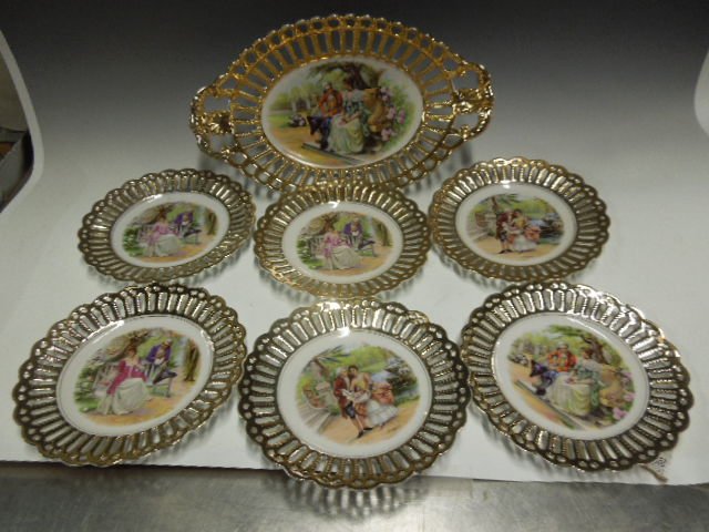 Bavarian Porcelain Desert Set: Bavarian porcelain desert set, gilt reticulated borders, transfer print centers with courting scenes; includes 12 1/2" x 7 1/2" oval bowl, & six 7" desert plates, early 20th c. CONDITION: No issues no
