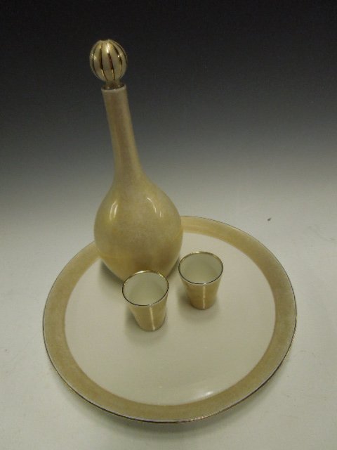 KPM Porcelain Cordial Set: KPM porcelain Cordial set, gold toned & white porcelain; includes 9 3/8" decanter, 2 shot glasses & 10" diameter tray, early to mid 20th c. CONDITION: No issues noted.