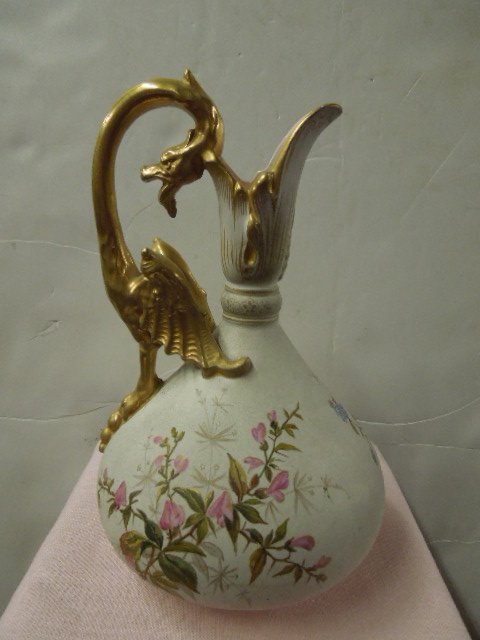 German Porcelain Ewer: German porcelain ewer, features gilt dragon handle & floral painted body, signed on base,late 19th/early 20th c. 9 1/2". CONDITION: No issues noted.