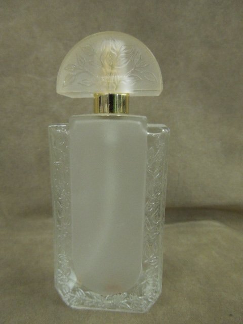 Lalique Eau De Parfum Spray Bottle: Lalique Eau De Parfum Spray bottle, clear and frosted with floral design on sides and cap, 1 1/2" x 2" x 4 5/8"h. CONDITION: No chips or apparent wear, empty.