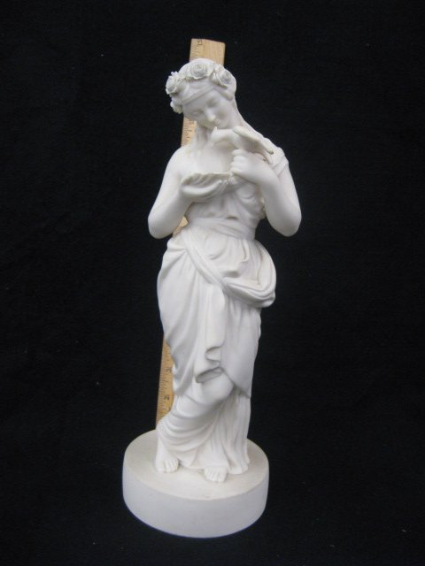 Victorian Parian Figure: Victorian Parian robed figure of a feeding bird & wearing a crown of applied delicate flowers; socle base. English, late 19th c. hgt 13". CONDITION: No issues identified.