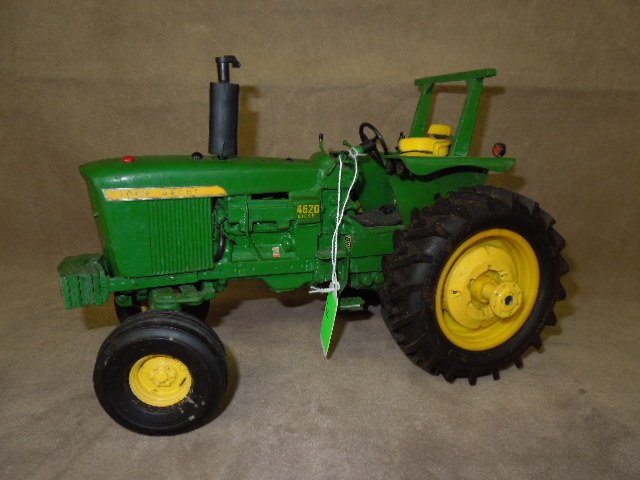 John Deere Die Cast Tractor by Ertl: John Deere 4620 die-cast tractor by Ertl. CONDITION: Used, no box, some pieces may be damaged or missing.
