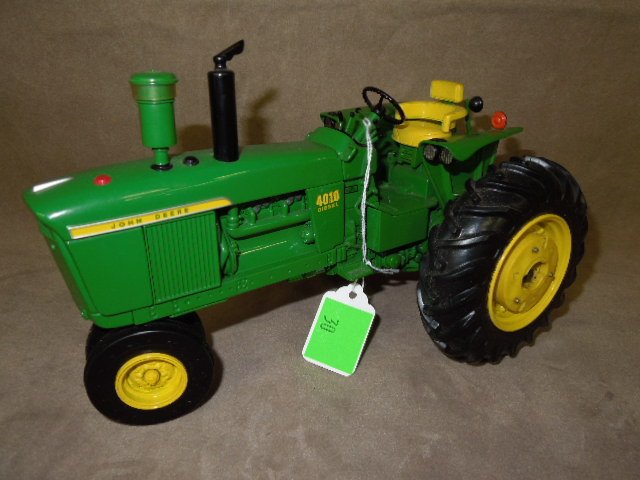 John Deere Die Cast Tractor by Ertl: John Deere 4010 die-cast tractor by Ertl. Appears as though there is factory decal blemish. There is a 4020 number under the 4010. CONDITION: Good, used, some pieces may be missing.