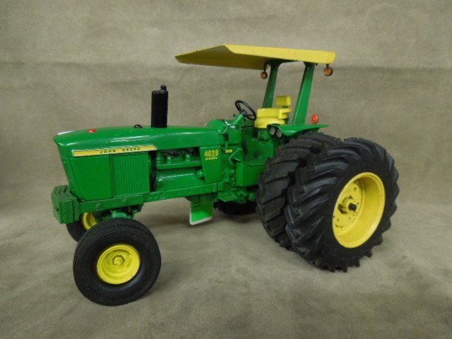John Deere Die Cast Tractor by Ertl: John Deere 4020 die-cast tractor by Ertl. CONDITION: Used, no box, some pieces may be damaged or missing.