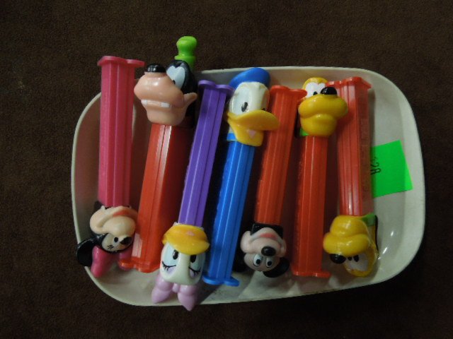 7 Disney Pez Dispensers: Seven Disney Pez dispensers, including: Minnie, Mickey, Donald, Daisy, Goofy & two Pluto, loose. CONDITION: Very minor wear.
