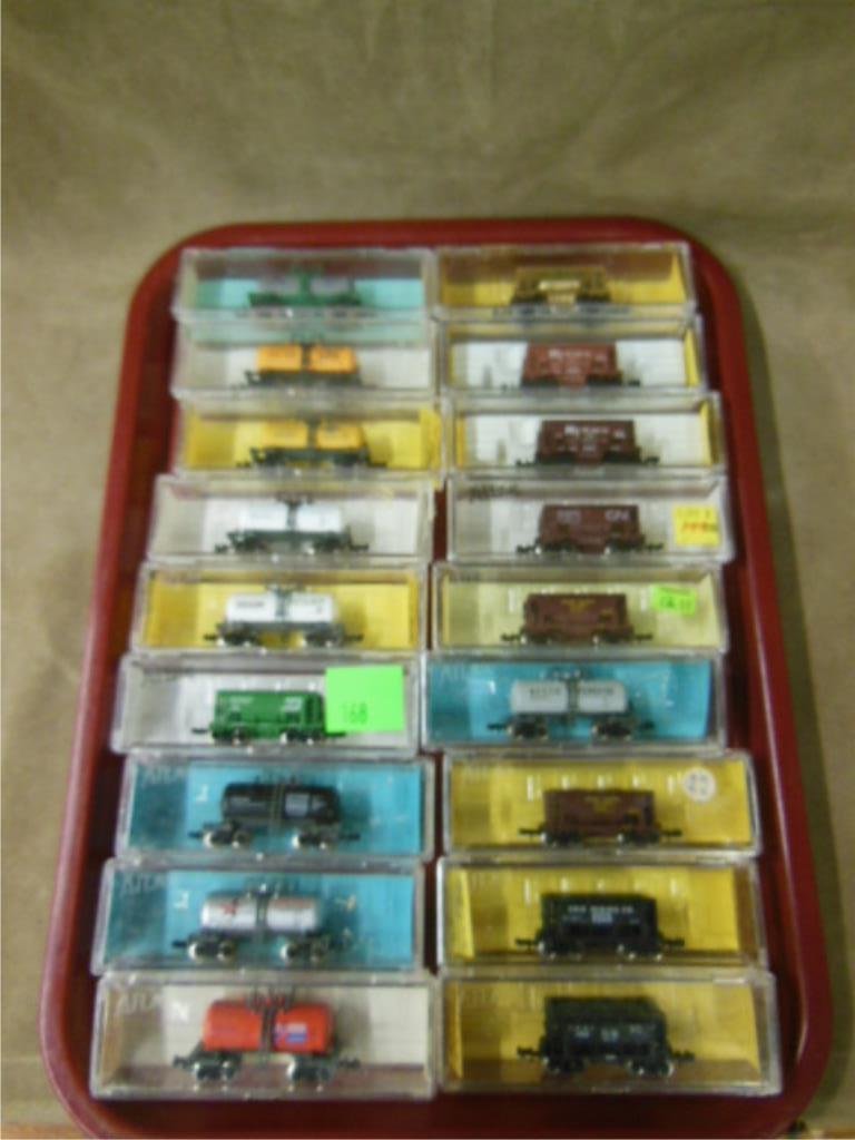 "N" Gauge Tank / Coal Cars: Eighteen Atlas & other assorted "N" gauge old store stock tank & coal cars; original plastic boxes. CONDITION: Minor wear from age.