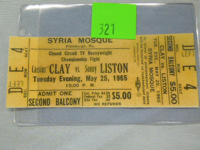 Clay vs. Liston Event Tickets: Cassius Clay vs. Sonny Liston ticket, May 25, 1965 at Syria Mosque, Pittsburgh, PA, second balcony, Sec D (left), row E. seat 4, admission $5.00 in plastic sleeve. #23 CONDITION: Minor wear from age, 