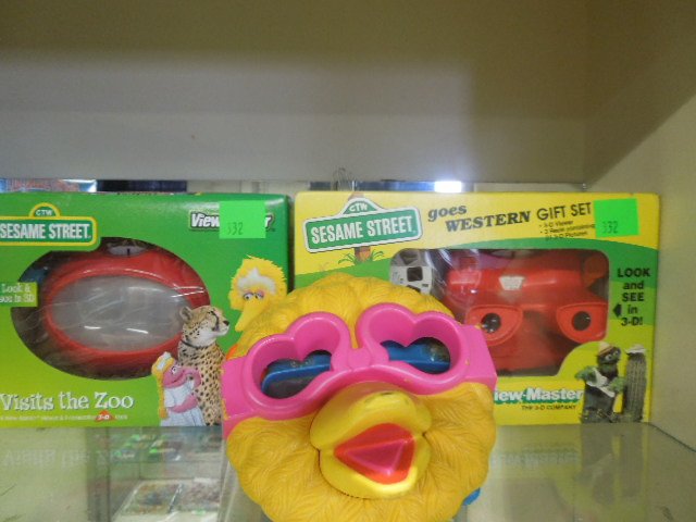 2 Sesame St View Master Gift Sets: Two Sesame Street View Master gift sets, in original boxes, plus one Big Bird face viewer. CONDITION: Good in packages, Bir Bird face loose from viewer.