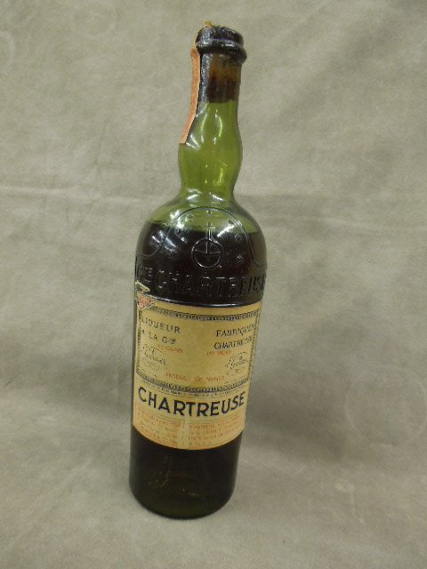 Bottle French Liqueur Chartreuse: 4/5 Quart bottle French liqueur chartreuse, A LA Gde L. Garnier, imported with ill. tax sticker & IRS tax stamp at top (missing half), late 19th / early 20th C. CONDITION: label has wear at bottom, as