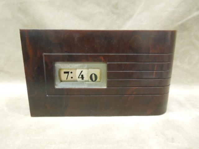 Catalin Electric Deco Clock: Catalin electric deco clock, solid case, open face at numbers, [27] 2 1/2" x 8 1/2" x 5" h CONDITION: Minor surface scratching, two dents to outside number cover plate.
