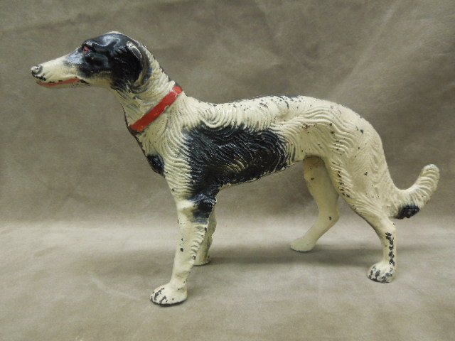 Vintage Painted Cast Iron Doorstop: Vintage painted cast iron doorstop, Irish Wolfhound in black and white, red eyes, and collar, unmarked, 13"L x 7 1/2"H. CONDITION: Significant paint loss along seem, minor loss else wear.