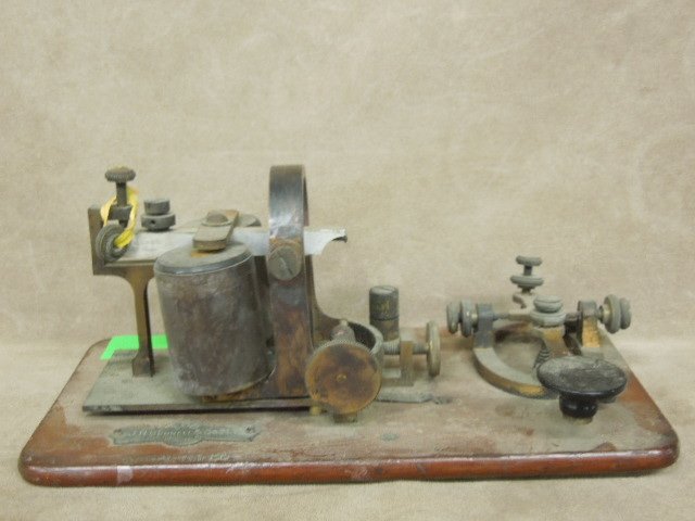 Vintage J. H. Bunnel & Co. Morse Code Telegraph: Vintage J. H. Bunnel & Co. New York Morse code telegraph key with wood base, marked "Postal Tel Co." components are made of steel & brass. CONDITION: Good, wear from age & use.