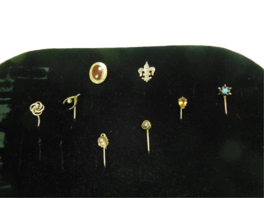 8 Gold & Gemstone Stick Pins: Eight gold & gemstone stick pins, tested 10 & 14k y gold, with diamond, pearl, opal, carnelian & topaz; 19th / 20th C., 5 DWT; some bends in pins. CONDITION: Normal wear, some bends in pins.