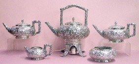 Bailey & Co. Sterling Silver Japonisme Tea Set: c. 1876-1878 Bailey & Co. sterling silver Japonisme movement 5 piece tea set w/repouse floral design, 10 1/2" coffee pot, 11" teapot, 6 5/8" open creamer, 6" open sugar bowl & 13" x 11" tea kettle on 