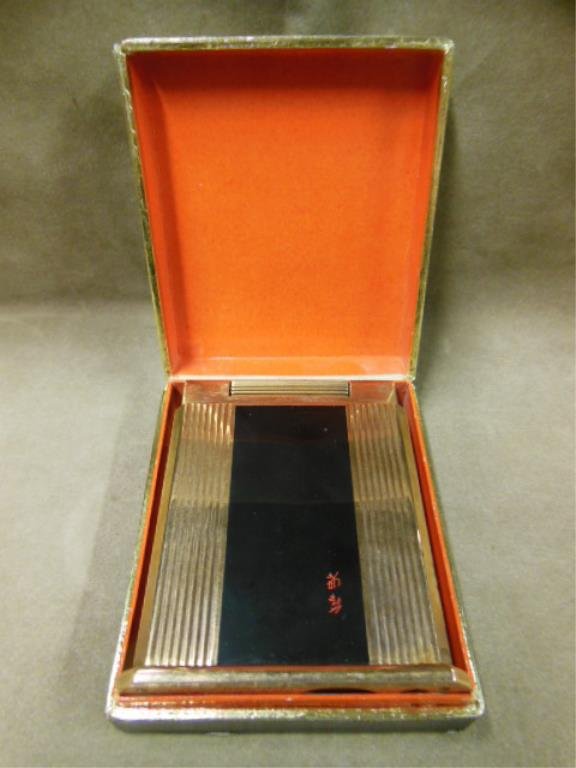 L.T. Dupont, Paris "Jeroboam" Table Lighter: L. T. Dupont, Paris "Jeroboam" table lighter, gold plated with black enameled panels one containing a red Japanese signature; includes original cardboard box; lighter top engraved with Winged Canon an