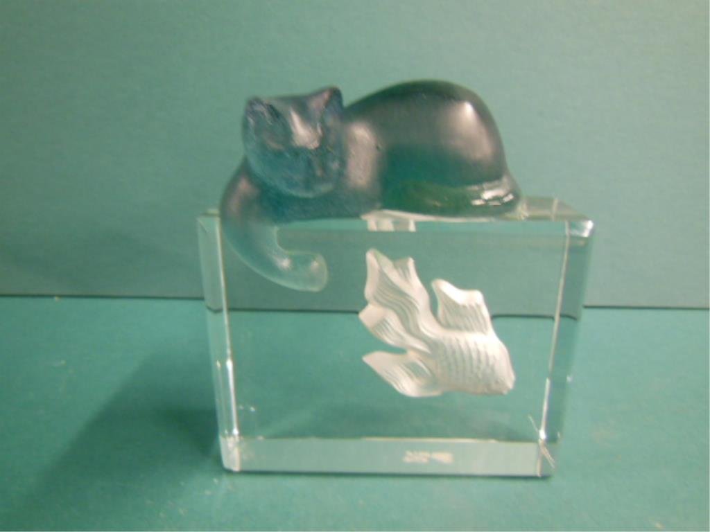Daum France Crystal Cat & Fish: Daum France crystal cat and fish figure group, clear crystal block surmounted by a green fronted glass cat, signed and paper label, H 5 3/8", L 4 3/4", W 2 1/2". CONDITION: No issues identified.