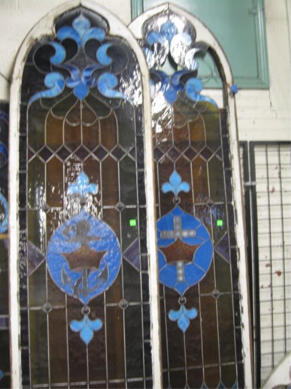 Pr Tall Leaded Glass Window Panels: Pr tall Leaded Glass Church Window Panels, wood framed, arched top, 1 with crown and cross, 1 with crown and anchor center decoration, 120" h x 32 1/2" w each CONDITION: 1 missing 3 large panes at top
