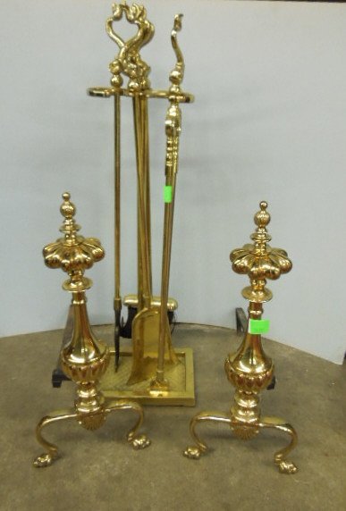 Fireplace Andirons & Tools: Fireplace andirons & tools, brass, finial crested reeded urn form andirons on fan crested claw feet; stand of four tools with dolphin handles, 20th C., andirons 21 3/4" h. CONDITION: No issues identif