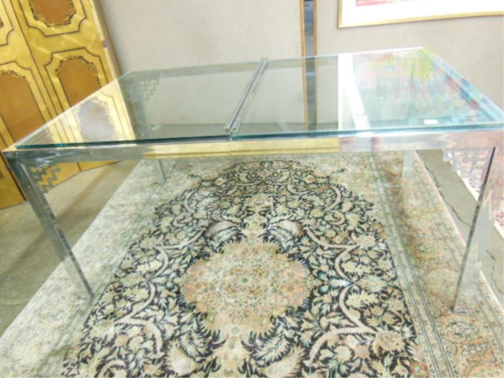 Modern Style Dining Room Table: Modern-style dining room table, chrome & plate glass, extension type with cut out top & corner brackets, c 1960-70. 38" x 59" x 28" CONDITION: Small areas of rust on corner brackets, no leaves.