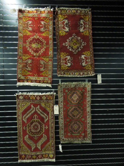 4 Antique Turkish Throw Rugs: Four antique Turkish throw rugs, the largest: 3'2" x 1'7". [12] CONDITION: All with chemical dyes & losses at ends; two with light wear in field.