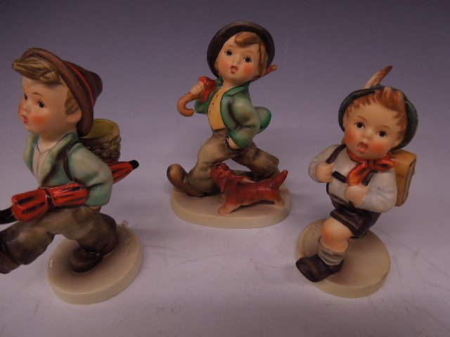 3 Hummel Figurines: Three Hummel figurines, Strolling Along, #5, 5"h; Globe Trotter, #79, 5" h & School Boy, #82 2/0, 4 1/2"h, all Mark 3. CONDITION: No chips, cracks or crazing.