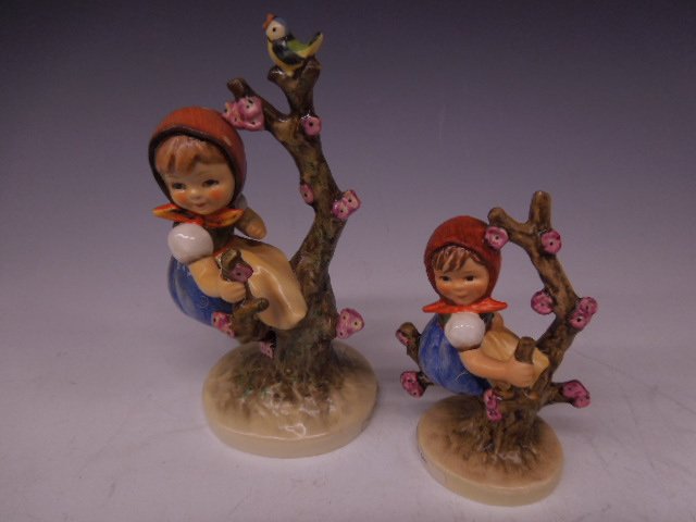 2 Hummels Large & Small Apple Tree Girl: Two Hummels large & small Apple Tree Girl, #141, Mark 3, 6" with bird & #141/0, Mark 6, 4 1/4"h; signed L.87 on bottom. CONDITION: No chips, cracks, larger has minor crazing throughout.