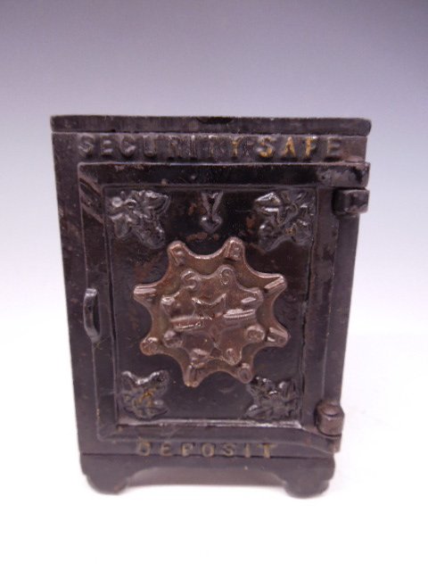 Cast Iron Safe Bank: Cast Iron Safe bank, Security Safe, marked 100,(on bottom), turn combination dial on front, floral block decoration, 3" sq. x 4 1/4"h Condition; enamel loss throughout, dial doesn't move