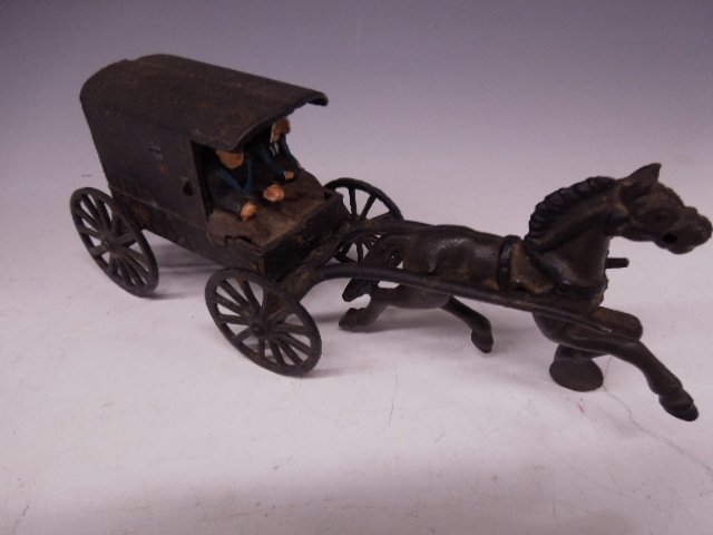 Cast Iron Horse Drawn Amish Carriage w/4 Figurines: Cast iron horse drawn Amish carriage with four figurines, early to mid 20th C., 10"l. CONDITION: Modest wear.