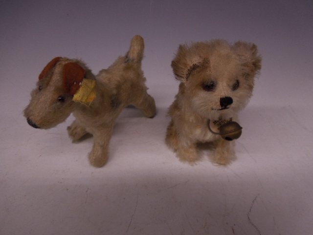 2 Steiff Dogs, "Molly 3310": Two Steiff dogs, "Molly 3310" with original pink ribbon, bell, pewter ear button with red label, glass eyes, 4"h, & fox terrier, mohair, glass eyes, ear button with worn yellow label, felt ears, 4"h, 