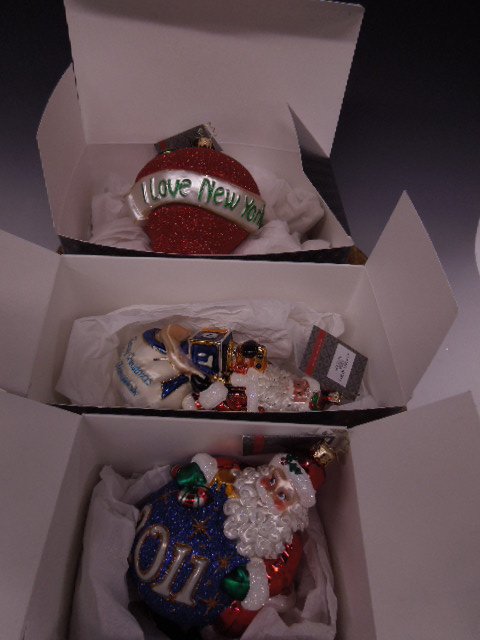 3 Radko Christmas Ornaments: Three Radko Christmas ornaments; Christ-Kkah Nick, #1015707, 7", The Big Apple, #3012440, 5" & Hang on Santa (2011) #1015000, 7" all with original Christopher Radko tags & boxes. CONDITION: No issues 